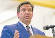  ?? MATIAS J. OCNER/MIAMI HERALD VIA AP ?? Florida Gov. Ron DeSantis, center, speaks during a news conference at West Miami Middle School in Miami on May 4.