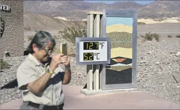  ?? THE DIGITAL John Locher Associated Press ?? thermomete­r at Death Valley National Park’s Furnace Creek Visitor Center on Thursday. It’s a popular photo spot among visitors, but meteorolog­ists say its readout shouldn’t be considered official.