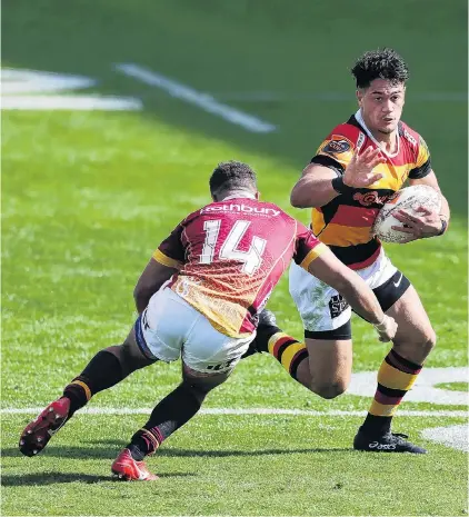 ?? PHOTO: GETTY IMAGES ?? No way through . . . Southland wing Isaac Te Tamaki prepares to tackle Waikato centre Quinn Tupaea during their Mitre 10 Cup match in Hamilton on Saturday night.