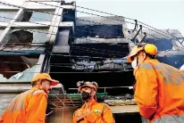  ?? ?? National Disaster Response Force (NDRF) and fire brigade personnel conduct a search and rescue operation after a fire broke out in a commercial building, in New Delhi (Reuters)