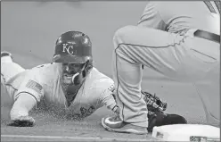  ?? Associated Press ?? You’re out: Kansas City Royals' Whit Merrifield, left, is tagged out by Cleveland Indians third baseman Jose Ramirez during the eighth inning of a baseball game at Kauffman Stadium in Kansas City, Mo., Wednesday.