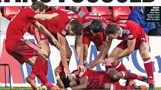  ??  ?? REDS’ RELIEF: Aberdeen players mob Shay Logan after his goal