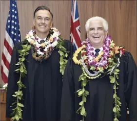  ?? The Maui News / MATTHEW THAYER photo ?? New judges Christophe­r M. Dunn (left) and James R. Rouse briefly shed their masks to pose for a photo after their swearing-in ceremony Thursday afternoon at Hoapili Hale in Wailuku.