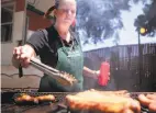  ?? Kevin N. Hume / The Chronicle 2014 ?? Dneva Waggoner of Sacramento grills Gourmet Poppers links at BottleRock.