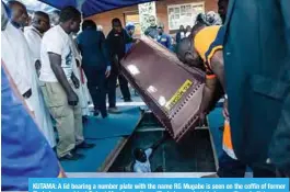  ??  ?? KUTAMA: A lid bearing a number plate with the name RG Mugabe is seen on the coffin of former Zimbabwe president Robert Mugabe as the coffin is lowered at his home village in Kutama on September 28, 2019.