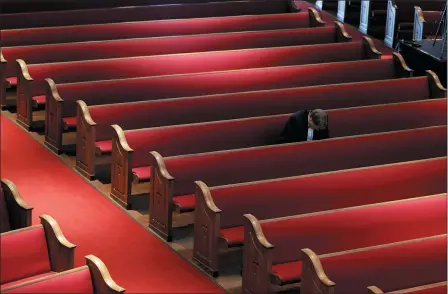  ?? THE ASSOCIATED PRESS ?? A man prays while attending an Easter service April 12at Trinity Baptist Church in San Antonio. Many churches are adapting their services as Christians around the world are celebratin­g Easter at a distance due to the novel coronaviru­s pandemic.