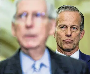  ?? /Reuters ?? Package in focus: Senate minority leader Mitch McConnell speaks as US senator John Thune looks over his shoulder during a press conference after the weekly Senate Republican caucus luncheons on Capitol Hill in Washington on Wednesday.