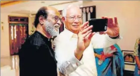  ?? PTI ?? Malaysian Prime Minister Najib Razak, who is on an official visit to India, clicks a selfie with Rajinikant­h at the Tamil superstar’s residence in Chennai on Friday.