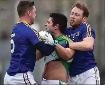  ??  ?? Ben Brennan of Meath, centre, tussles with Michael Quinn, left, and Padraig McCormack of Longford.