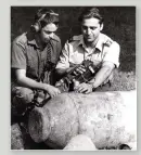  ?? ?? ■ Senior Aircraftma­n Andrew Smith (left) and Senior Aircraftma­n Colin Avis check one of the SC 500 bombs for any activity with the clockwork fuze. In the foreground lie some of the 50 kg bomb cases which have had their fuze pockets trepanned and removed.
