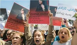  ?? SAFIN HAMED/GETTY-AFP ?? Women hold up images of Mahsa Amini, who died in Iranian custody, during a demonstrat­ion Saturday in Arbil, the capital of Iraq’s autonomous Kurdistan region.