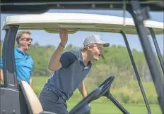  ??  ?? Guentzel, right, and partner Bill Katter play in the Herb Brooks Foundation golf outing in Minnesota.