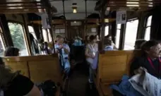  ?? ALESSANDRA TARANTINO PHOTOS/THE ASSOCIATED PRESS ?? Passengers sit on a train to the papal summer estate in Castel Gandolfo.