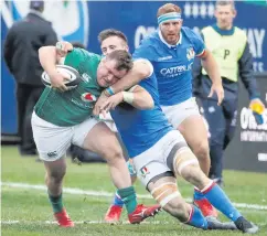  ??  ?? All action: Ireland’s Dave Kilcoyne is tackled by Italy’s Abraham Steyn at Soldier Field in Chicago