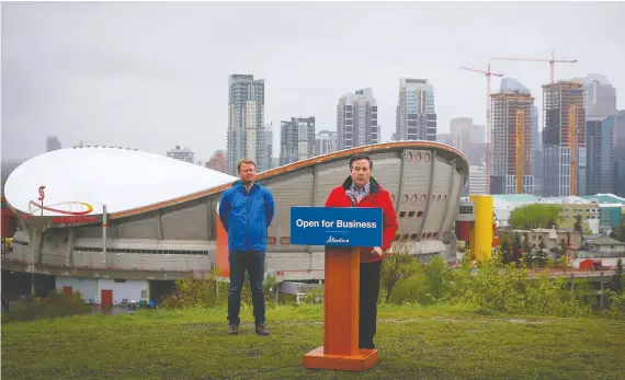  ?? AL CHAREST ?? Premier Jason Kenney, with provincial Health Minister Tyler Shandro behind him, said Friday, “COVID-19 still poses a very real risk. We must all continue to act responsibl­y.”