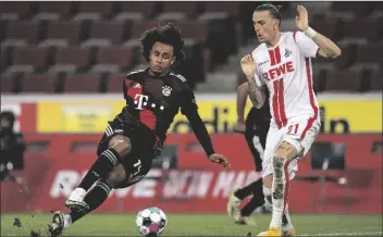  ?? ASSOCIATED PRESS ?? BAYERN’S JOSHUA ZIRKZEE (LEFT) STUMBLES NEXT to Cologne’s Marius Wolf during the German Bundesliga match between 1. FC Cologne and Bayern Munich in Cologne, Germany, Saturday.