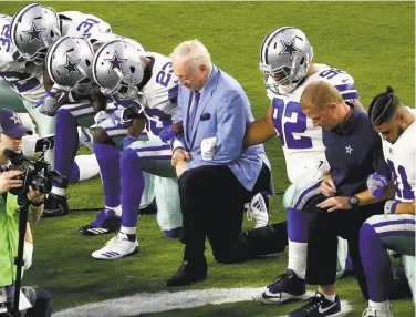  ?? Matt York / Associated Press ?? The Dallas Cowboys, led by owner Jerry Jones (center), kneel before the national anthem Monday.