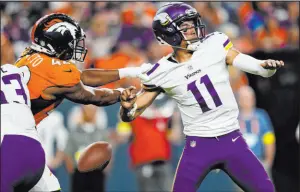  ?? Jack Dempsey
The Associated Press ?? Broncos linebacker Nik Bonitto strips the ball from Vikings quarterbac­k Kellen Mond in the second half of Denver’s 2313 victory Saturday at Empower Field at Mile High.