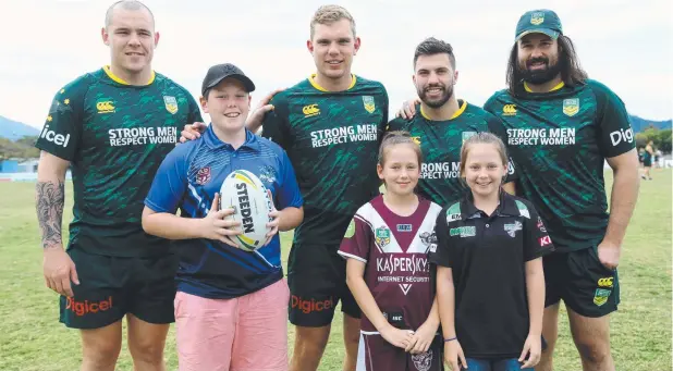  ?? Picture: STEWART McLEAN ?? PROUD MOMENT: David Klemmer, Tom Trbojevic, James Tedesco and Aaron Woods from the Australian Prime Minister's XIII rugby league team with Bentley Park siblings Beau, 13, Zoe, 9, and Ella Stevens, 11, at Jones Park in Cairns yesterday.