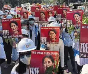  ?? — AP ?? People’s choice: A file photo showing protesters holding portraits of Suu Kyi during an anti-coup demonstrat­ion in Mandalay.