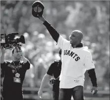  ?? Jose Luis Villegas/ Sacramento Bee/ TNS ?? Former San Francisco Giants star Barry Bonds is all smiles after throwing out the ceremonial first pitch to a standing ovation prior to action against the Philadelph­ia Phillies in Game 3 of the NLCS in San Francisco on Oct. 19, 2010.