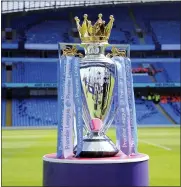  ?? THE ASSOCIATED PRESS FILE ?? In this May 6, 2018 file photo, the English Premier League trophy is displayed on the pitch prior to the English Premier League soccer match between Manchester City and Huddersfie­ld Town at Etihad stadium in Manchester, England.