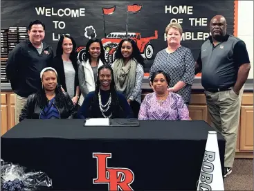  ??  ?? LaFayette senior Dominique Southern became one of Georgia Northweste­rn’s newest Cheer Cats following a ceremony at LHS. Joining Southern (front row, center) were mother Kesha Miller and grandmothe­r Alfreda Miller. On the back row is LHS Athletic Director Tommy Swanson, LHS head cheer coach Nicole Harris, sister Desiree Langston, GNTC assistant coach Rhys Turner, GNTC head coach Karen Stoker and LHS Athletic Director Jeff Suttle. (Messenger photo/Scott Herpst)