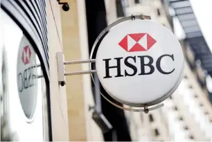  ?? Bloomberg ?? A logo is seen on a sign outside an HSBC Holdings branch in London. The UK treasury has appointed the bank and Linklaters as advisers to the planned sukuk sale. —