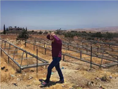  ?? ANNE-MARIE O’CONNOR FOR THE WASHINGTON POST ?? Waseem Al-Ja’bari surveys the damage at the empty racks for solar panels confiscate­d by Israeli authoritie­s.