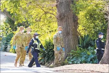  ?? Asanka Brendon Ratnayake Associated Press ?? AUSTRALIAN troops and police conduct patrols to ensure compliance with lockdown orders in Melbourne. Hundreds of new daily cases and untraceabl­e community transmissi­ons led to a curfew and other measures.
