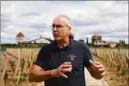  ?? Associated Press photos ?? Fabien Teitgen, technical director of the of the Château Smith-Haut-Lafitte estate, explains the conditions of this historical­ly hot summer in Martillac, south of Bordeaux, southweste­rn France, on Monday. Teitgen said wine producers “must adapt” to the effects of climate change.