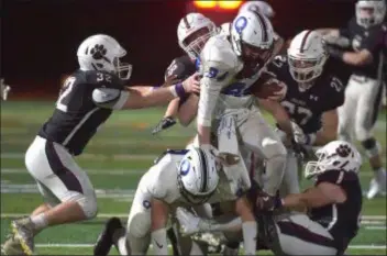  ?? PETE BANNAN — DIGITAL FIRST MEDIA ?? Quakertown running back Christian Patrick is surrounded and tackled by Garnet Valley defenders, from left, Jake Morin, Evan Hrivnak, Steven Patterson and Luke Shoemaker Friday night.