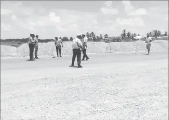  ??  ?? The driver of the truck, Mohan Dass (second, from left), watches on as police officers take measuremen­ts at the scene of the accident.