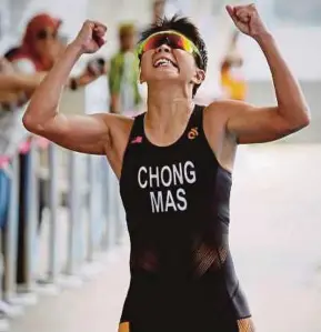  ??  ?? Irene Chong See Win bags the bronze medal in the triathlon event at Putrajaya yesterday. PIC BY MOHD KHAIRUL HELMY