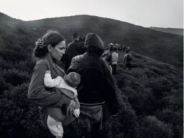  ??  ?? Clockwise from top left: Refugees and migrants safely reach the Greek coast.
Syrian mother holds her baby just after crossing the sea border between Turkey and Greece.
Refugees line up to get food in Idomeni, Greece.
Migrants from Syria and Afghanista­n reaching the northern Serbian town of Sid.