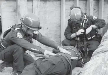  ??  ?? Emergency personnel take part in Exercise Coastal Response in Port Alberni in June. It was the province’s largest, full-scale disaster exercise, simulating a 9.0 earthquake and subsequent tsunami. Volunteers played the part of injured victims.