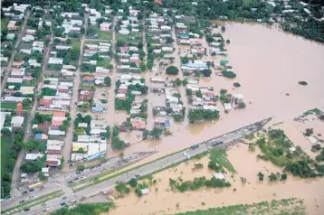  ?? ORLANDOSIE­RRA/GETTY-AFP ?? The municipali­ty ofChamelec­on on the outskirts ofSan Pedro Sula is floodedWed­nesday after Hurricane Iota passed through Honduras.