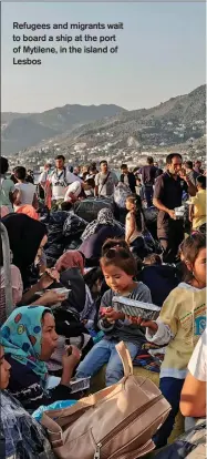  ??  ?? Refugees and migrants wait to board a ship at the port of Mytilene, in the island of Lesbos