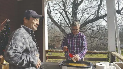  ??  ?? Jerry Compton serves his mom’s venerable recipe for black-eyed peas to David Brooks on New Year's Day at the Laurel Mills Store, where Mary Frances Fannon (also pictured here with Compton) started the tradition more than a quarter-century ago.