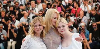  ??  ?? (From left) US actress Kirsten Dunst, Australian-US actress Nicole Kidman and US actress Elle Fanning pose yesterday during a photocall for the film ‘The Beguiled’ at the 70th edition of the Cannes Film Festival in Cannes, southern France.