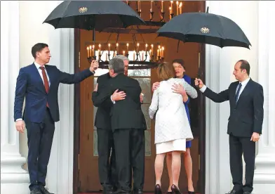  ?? FABRIZIO BENSCH / REUTERS ?? Incoming German President Frank-Walter Steinmeier and his wife Elke Buedenbend­er greet outgoing President Joachim Gauck and his partner Daniela Schadt at the Bellevue Palace in Berlin on Sunday.