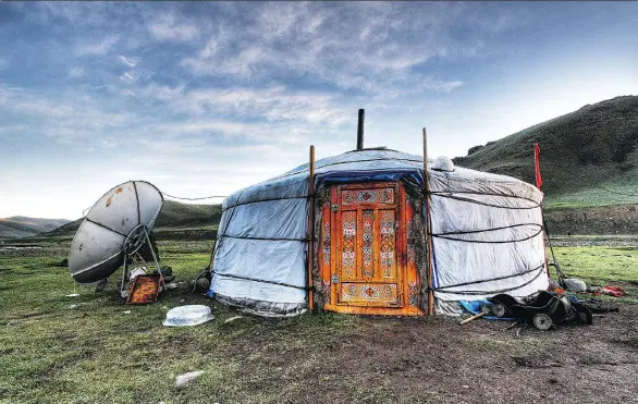  ?? GETTY IMAGES ?? A yurt with a satellite TV dish is powered by an array of solar panels that sit on the yurt’s roof.