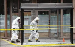  ?? COLE BURSTON / GETTY IMAGES ?? Hazmat workers scour the crime scene at Yonge St. in Toronto on Tuesday in the wake of Monday’s fatal incident. A suspect identified as Alek Minassian, 25, is in custody after a driver in a white rental van collided with multiple pedestrian­s, killing...