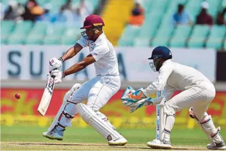  ?? AFP PIC ?? Windies’ Kieran Powell in action while Indian wicketkeep­er Rishabh Pant watches in their match in Rajkot yesterday.