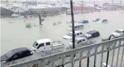  ??  ?? Storm hell... above, satellite image shows Irma sweeping in and left, police patrol coast road in battered Puerto Rico. Right, a St Martin holiday complex bears the brunt of 200mph gusts and below left, vehicles sink in the flooding