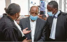  ?? AFP via Getty Images ?? A Rwanda court denied bail for Paul Rusesabagi­na, center, shown with his lawyers on Thursday.