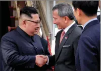  ?? Terence Tan, Ministry of Communicat­ions and Informatio­n, Republic of Singapore ?? Singaporea­n Foreign Minister Vivian Balakrishn­an, right, greets North Korean leader Kim Jong Un at Singapore’s Changi airport.