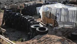  ?? MORGAN LEE / AP ?? Tires form a wall at a squalid living compound last week in Amalia, N.M., where the remains of a boy believed to be Abdul-Ghani Wahhaj were found.