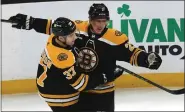  ?? STAFF PHOTO BY NANCY LANE — BOSTON HERALD ?? Boston Bruins defenseman Hampus Lindholm, right, celebrates his goal with Patrice Bergeron during the first period of a Jan. 22 game against the San Jose Sharks in Boston.