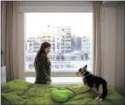  ??  ?? Jaana Matila, 29, an unemployed coder with three computing degrees, is seen at home last month in her Oulu home with her dog.